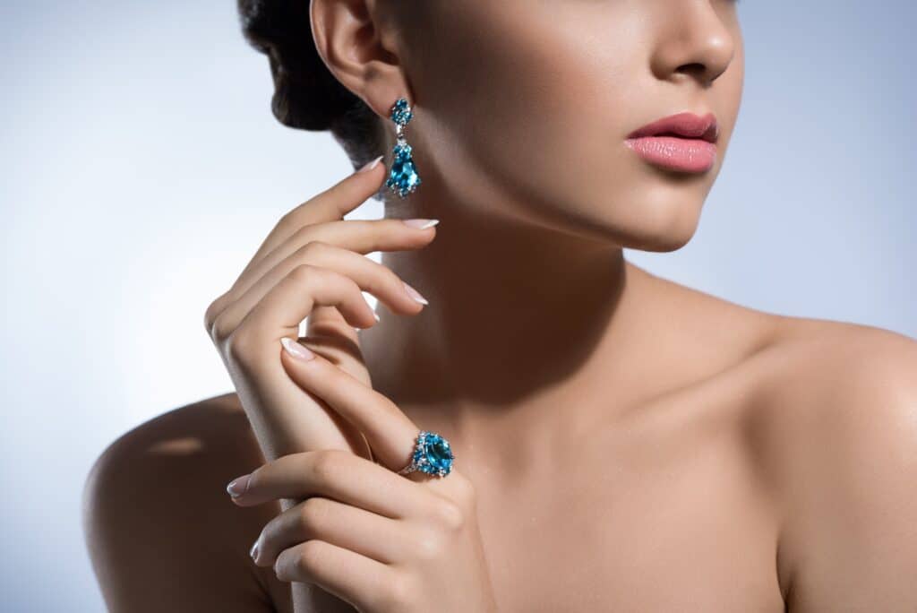 Gorgeous woman with precious jewelry in studio